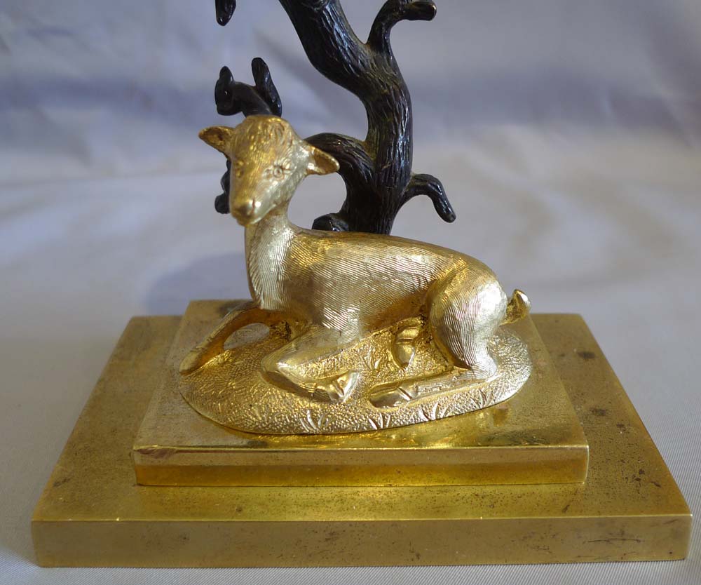 Antique English Regency candlestick of deer and squirrels in patinated bronze and ormolu.