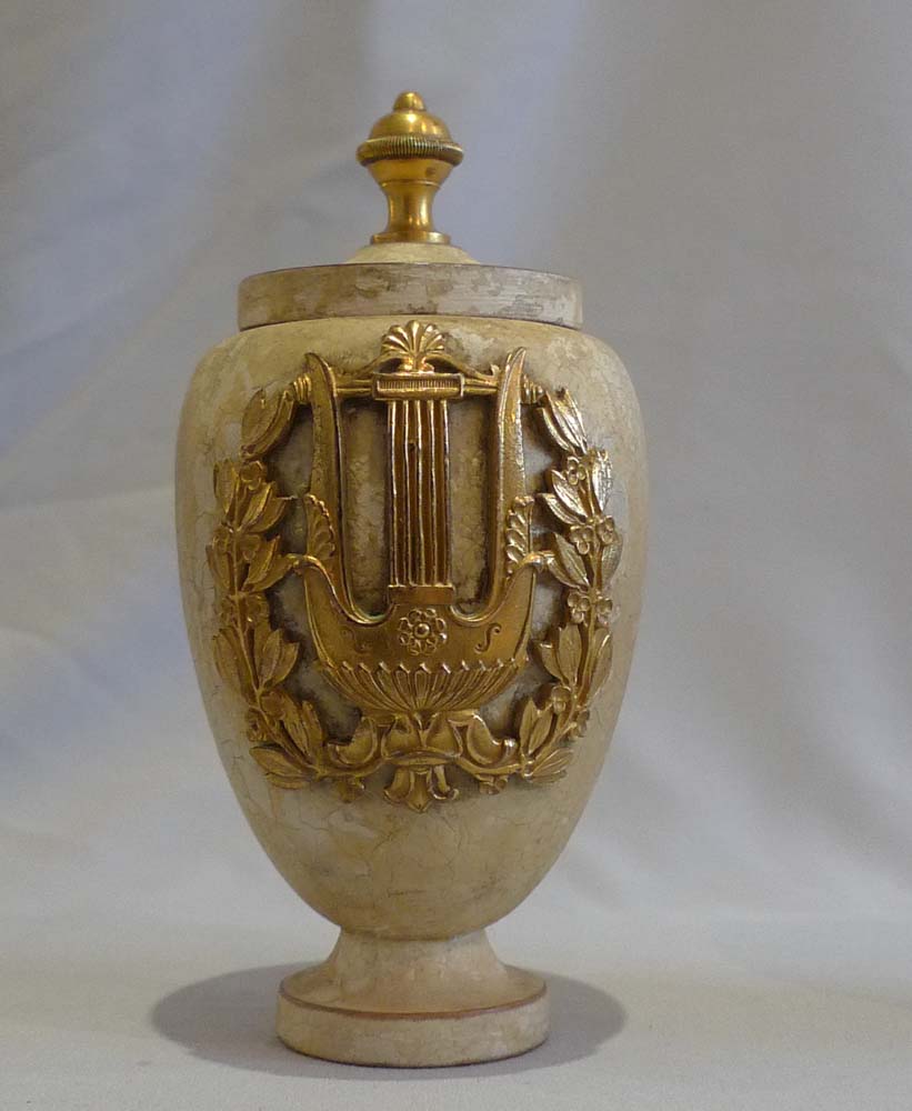 Antique pair of turned and painted covered urns with fine ormolu mounts