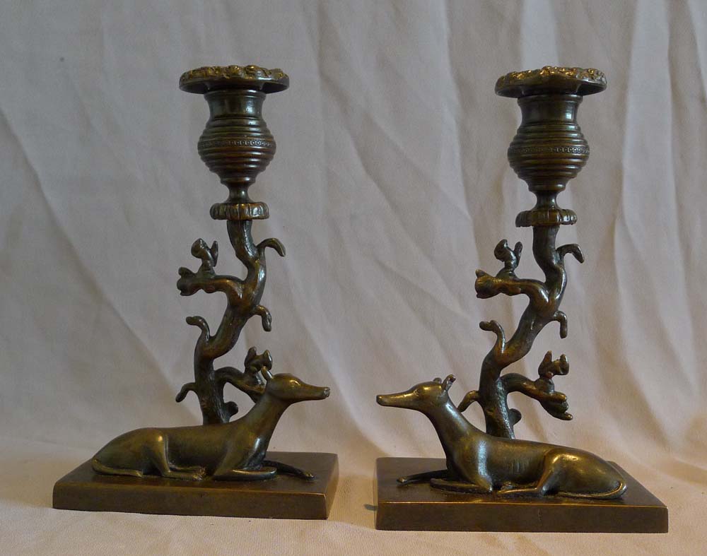 Antique late English Regency naïve true pair of animalier candlesticks of greyhounds and squirrels.