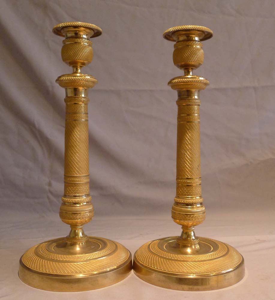 Antique and superb pair of French Empire ormolu candlesticks.