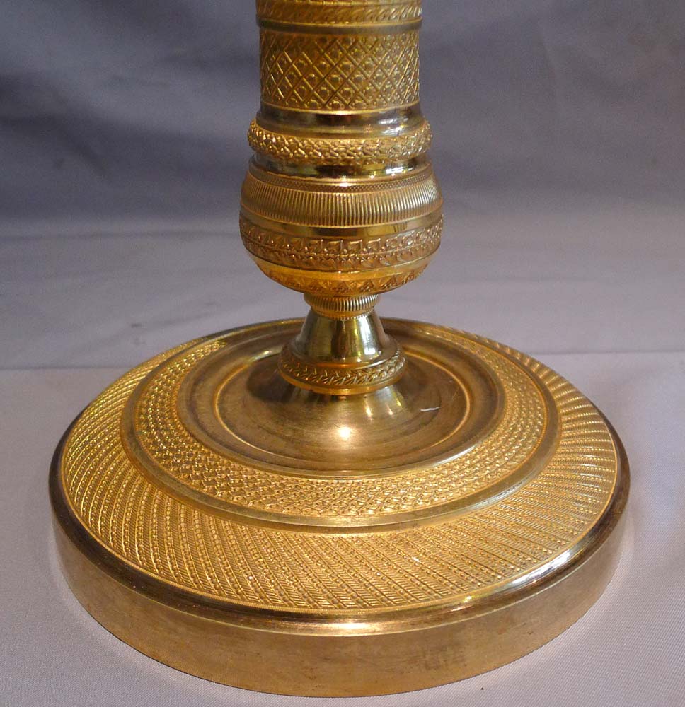 Antique and superb pair of French Empire ormolu candlesticks.