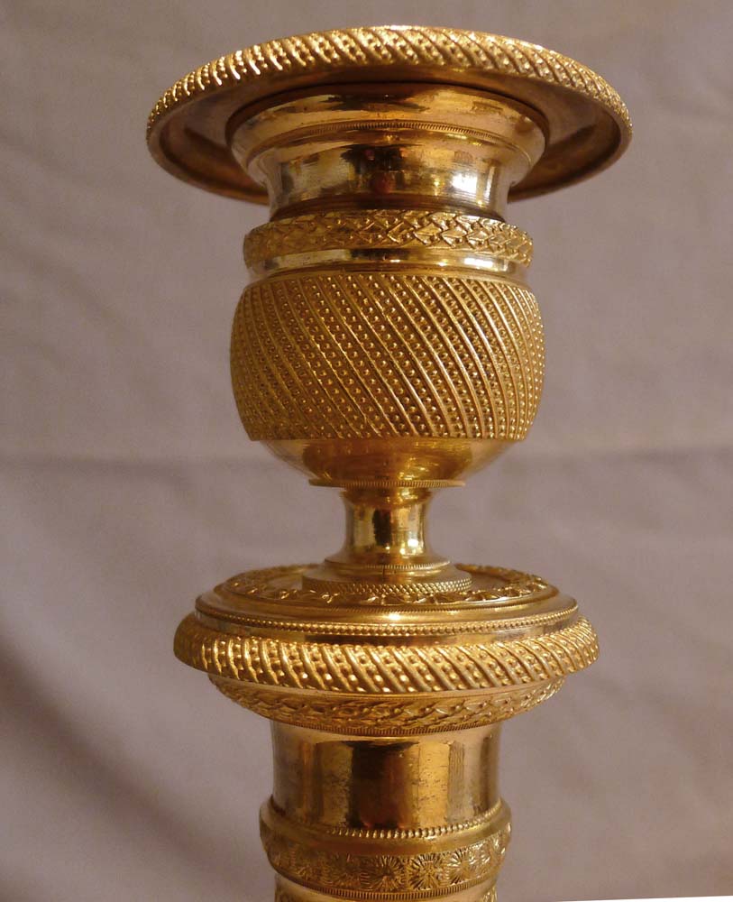 Antique and superb pair of French Empire ormolu candlesticks.