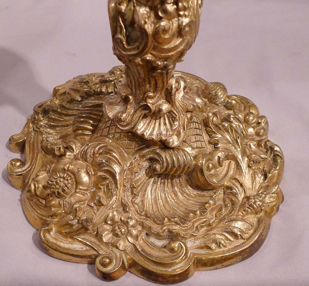 Antique pair of French ormolu candlesticks in the Louis XVth rococco style.