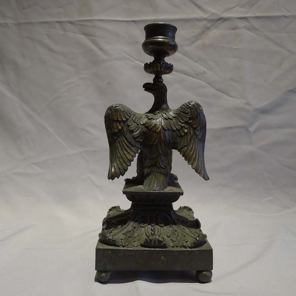 English Regency patinated bronze candlestick in the form of an eagle.