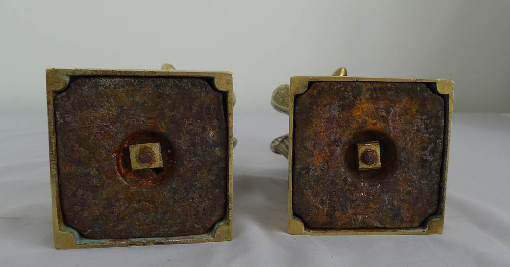 Antique pair of English bronze candlesticks of kneeling winged figures.