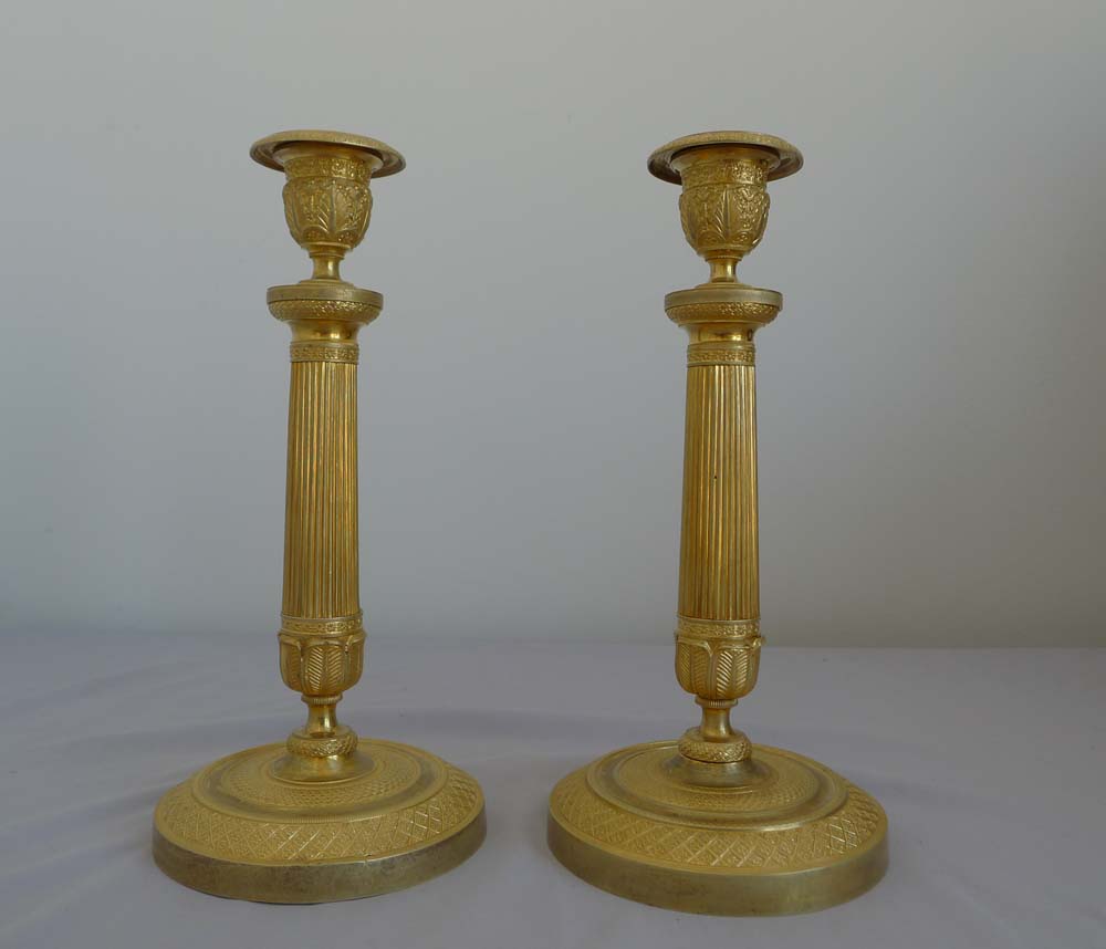 Antique pair of Charles X antique French ormolu candlesticks.