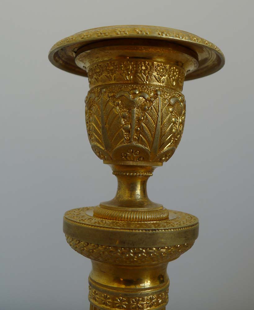 Antique pair of Charles X antique French ormolu candlesticks.