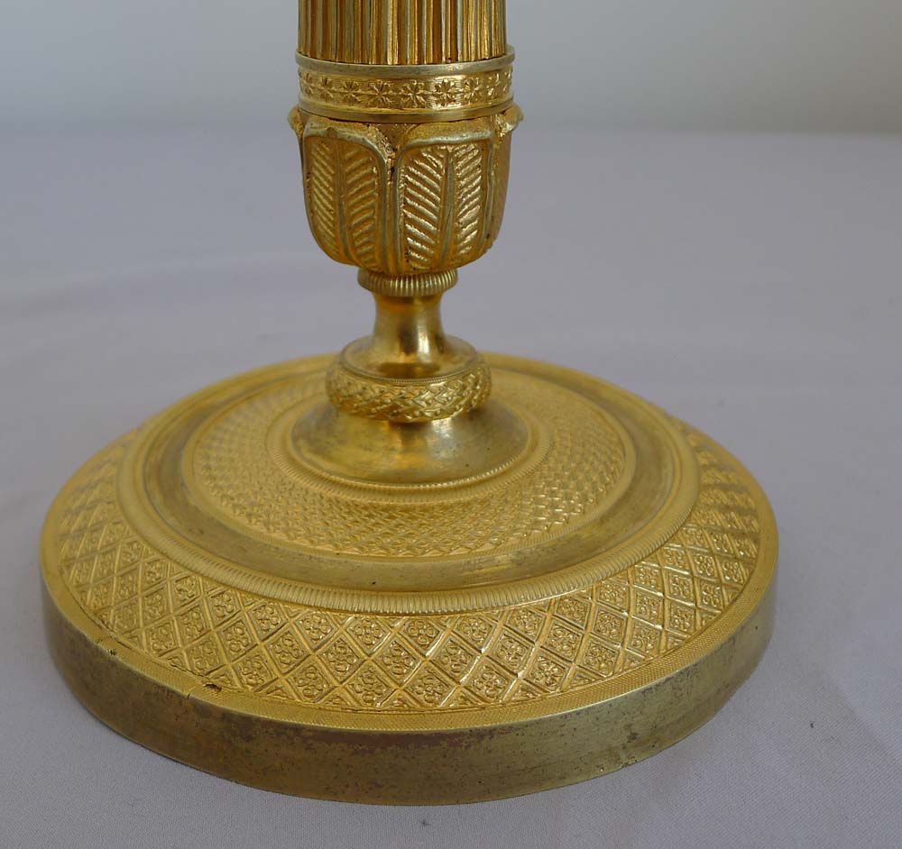Antique pair of Charles X antique French ormolu candlesticks.