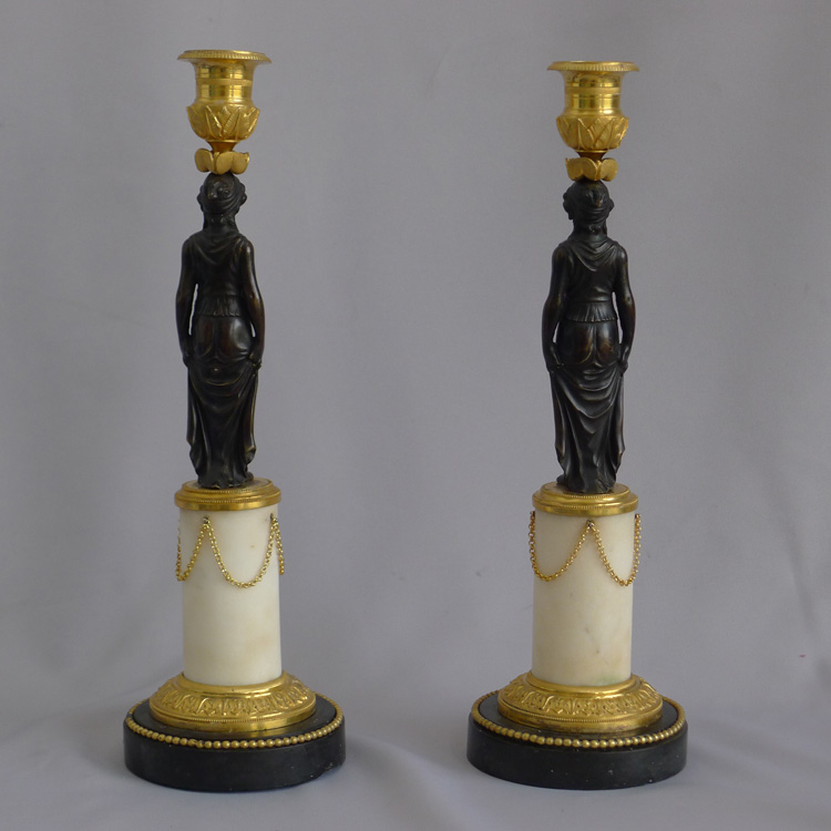 Pair of antique French Empire patinated bronze, ormolu, white & black marble figural candlesticks