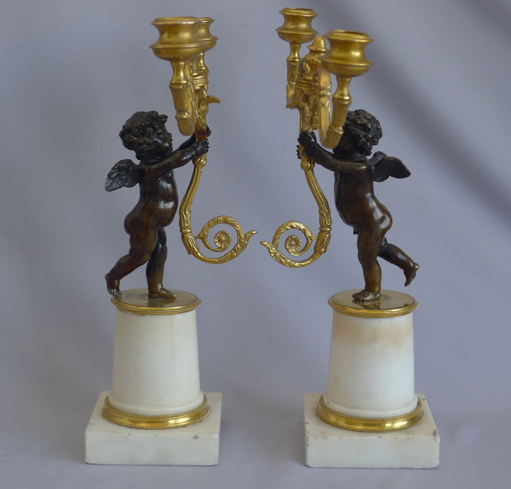 Pair Antique English Regency figural candlesticks in carrera marble, ormolu and patinated bronze